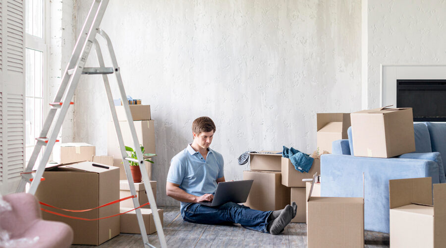 a man working with laptop on floor